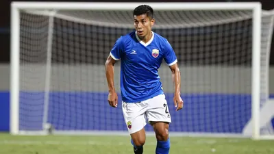 A 25-year-old Ecuadorian football player, wearing a blue jersey with white sleeves and white shorts, looks determined as...
