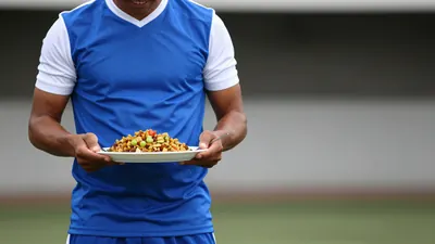 A photorealistic image of an anonymous Ecuadorian player, aged 25-30, wearing a blue jersey with white sleeves and a...