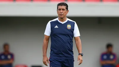 A photorealistic image of an anonymous Ecuador national team coach in his mid-40s, with a strong build, wearing a navy...